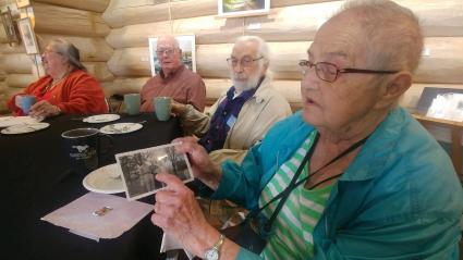 Eleanor Waha points out her friend Wayne Anderson in a historical photo. Photo by Rhonda Silence