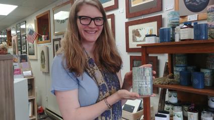 Abby Tofte with one of her favorite offerings at her store -- lovely, fragrant candles