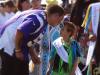 Grand Portage Rendezvous Days PowWow Arena Director Brandon Deschampe Morrison talks with young dancer, Tristan Olson