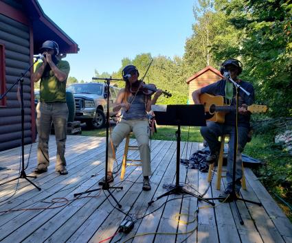 Jerry Vandiver, Caitlin Evanson, and Jay Gustafson perform outside WTIP.