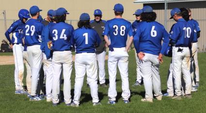 A pep talk from Coach during the first playoff game vs. Ely. Photo by Renee Buryanek