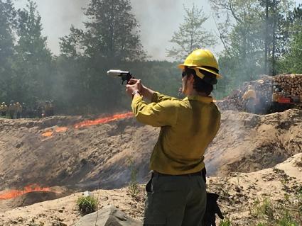 A trainee practices using a firing device to ignite a controlled burn. Photo courtesy of MN Wildfire Academy