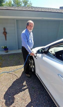 Bob Padzieski charges his electric vehicle at home before a ride up the Gunflint. Photo by Ginny Padzieski