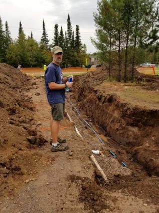 Builder Matt Groth of Grand Marais Construction working on the water and sewer lines to phase 1 of his project. Submitted photo