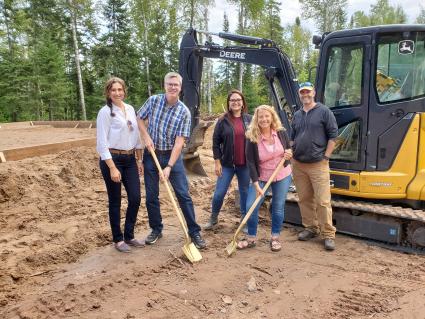 The co-owners of Northshore Laundry Services celebrate construction getting underway. Photo by Rhonda Silence