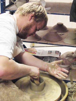 Cooper Ternes works on a bowl for the Empty Bowls event/photo by Joan Farnam