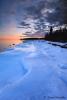 February sunset over shore ice - Grand Portage by Travis Novitsky