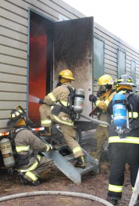 Firefighters entering the simulated fire trailer 6-13-21 Photo by Rhonda Silence.