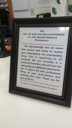 Grand Marais Pharmacy - a sign asks for patients for patience during this time of transition. Photo by Rhonda Silence