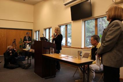 Tonia Tewell (center) speaks to a large crowd at the community center May 18. Photo by Joe Friedrichs