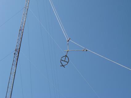 Part of the antenna is hoisted back up to the tower using an electric winch/photo by BJ Johnson 