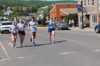 Law Enforcement Torch Run participants bringing the Flame of Hope into Grand Marais - Photo by Rhonda Silence