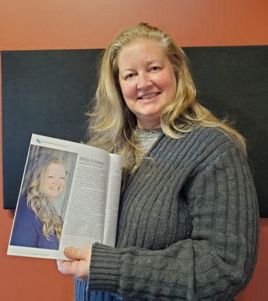 Marja Erickson, assistant vice-president at Grand Marais State Bank, with the magazine in which she is featured. WTIP photo