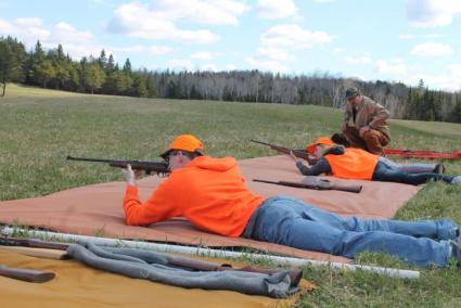 Participants in the DNR Firearms Safety course practice under the watchful eye of instructor Paul Eiler. Photo by Rhonda Silence