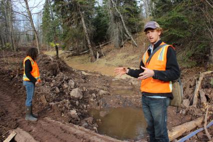 Phil Larson explains a restoration project near the Poplar River while Ilena Hansel looks on. All photos by Joe Friedrichs