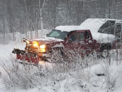 Plow trucks, large and small, are out in force today clearing roads, driveways and parking lots. Photo by Rhonda Silence