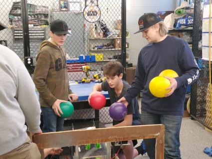 Robotics team members load the  IceStorm 3045 robot. Photo by Rhonda Silence