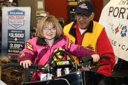 Easter Seals Ambassador Emily Pike with Tony Swader of the Grand Portage Trail Riders preparing for Snowarama. TBNW photo 