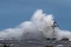 Waves crash over the breakwall by Stephan Hogland