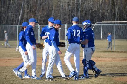 Excited Vikings huddle around No.12, Sophomore Paul Dorr, in the 6th inning vs Carlton on April 22. Photo by Michael McHugh