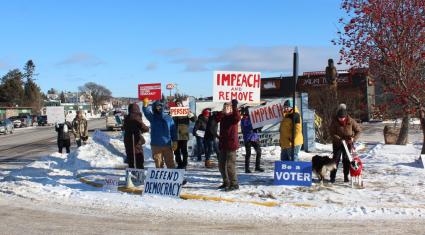 A group rallies Dec. 18 in Grand Maris in support of impeaching President Donald Trump. Photo by Joe Friedrichs