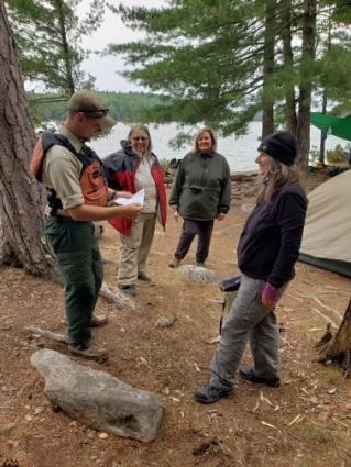 Wilderness rangers meet with BWCA paddlers during 2021 evacuation. Photo courtesy of USDA Forest Service 