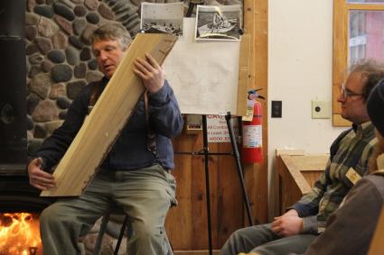 North House Folk School instructor John Beltman holds a piece of elm that once stood on Hwy 61 . Photo by Joe Friedrichs