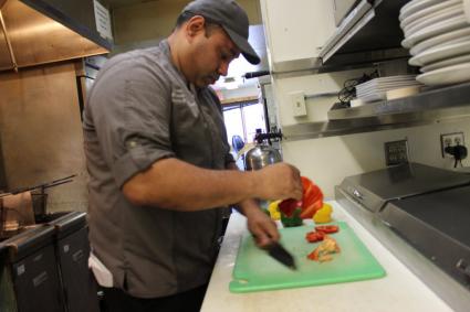 Chef Luis Cortes preps a pepper for dinner service at Bluefin Grille in Tofte. Photo by Joe Friedrichs