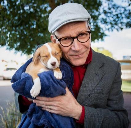 Clive Wynne, ASU professor of psychology, holding a puppy. Photo by Deanna Dent/ASU.