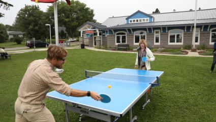 Grand Marais Mayor Jay Arrowsmith-Decoux plays ping pong with the Lt. Gov. Photo via Moving Matters/Sawtooth Mountain Clinic