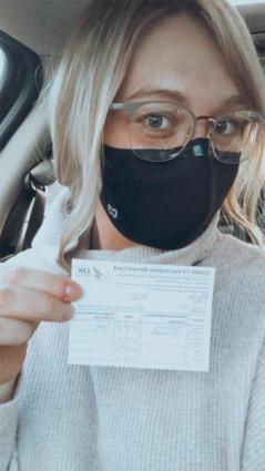 Katie Mumm holds a certification card after getting vaccinated for COVID-19 Jan. 22. Submitted photo