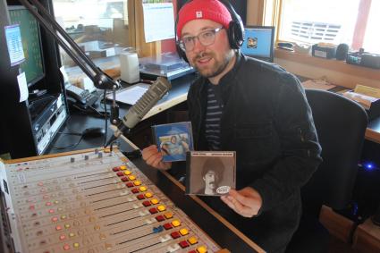 WTIP Music Director Will Moore with a pair of John Prine albums. Photo by Joe Friedrichs